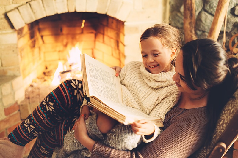 mother and child in front of the fireplace